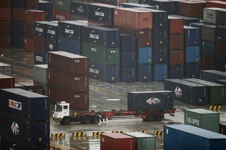 In this March 5, 2010 file photo, a tractor truck transports one of shipping containers at Yangshan deep-water port in Shanghai, China. China has called on Washington to cool its "politicization and emotionalization" of the trade issue.